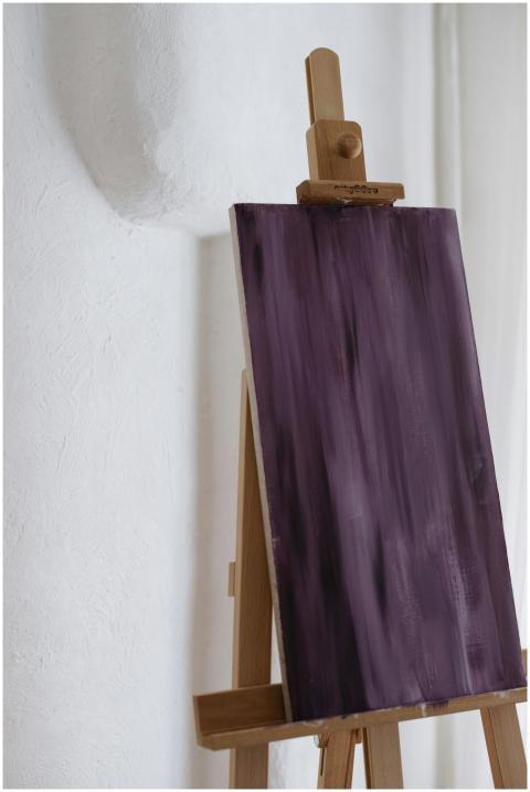 A vertical abstract painting with deep purple hues