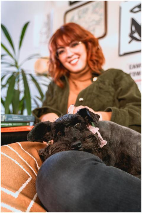 Woman smiling with her schnauzer dog relaxing toge