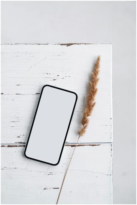 Top view of a smartphone mockup on a white rustic