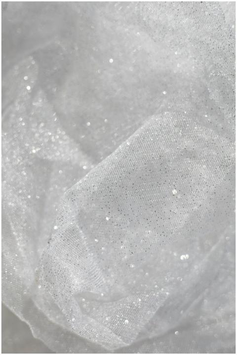 A close-up of white shimmering fabric texture with