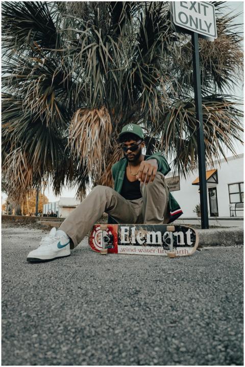 Young stylish man in a casual outfit posing with a