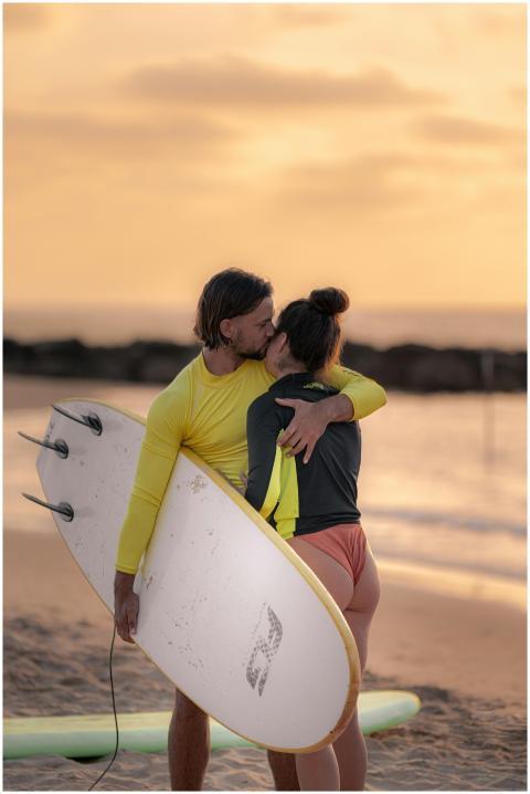 Couple embracing on Tel Aviv beach at sunset holdi