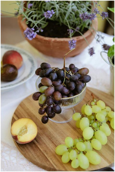 Tablescape with grapes, peach, and lavender plants