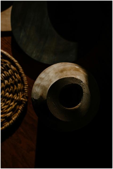 A moody minimalist still life featuring ceramic an