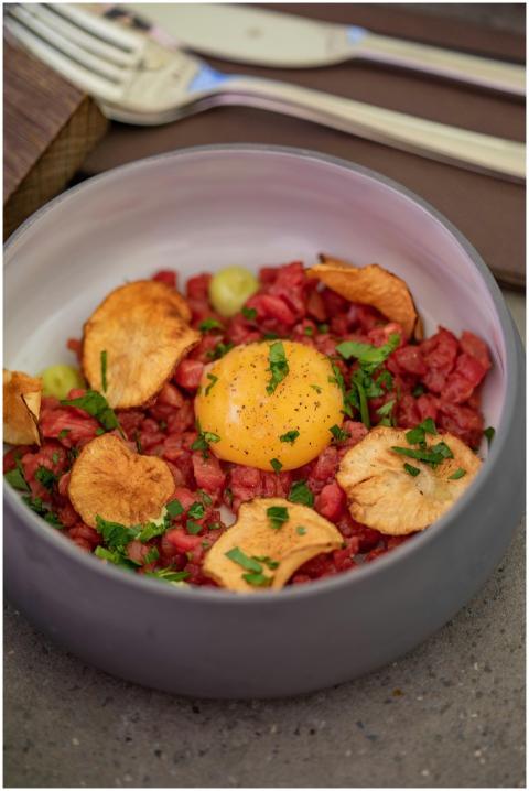 From above delicious steak tartare dish with potat