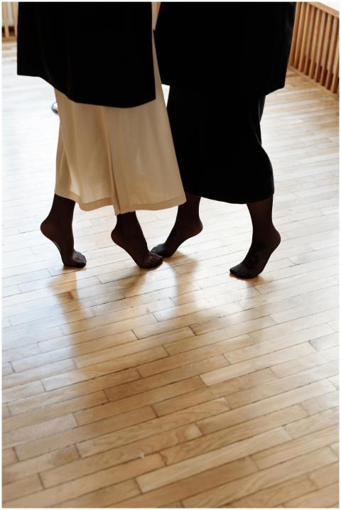 Two people dancing together indoors, showcasing in