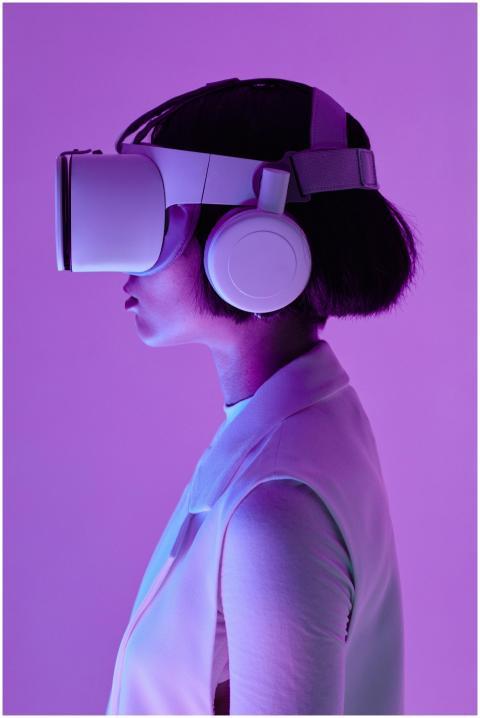 Side profile of a woman wearing VR goggles in a st