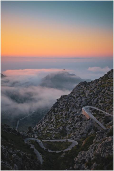 Winding road on Mallorca's mountains at sunset wit