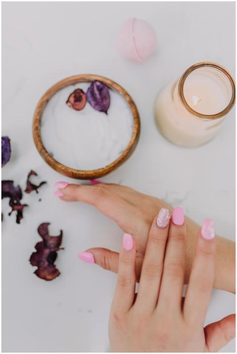Beautiful pink manicure and spa products create a