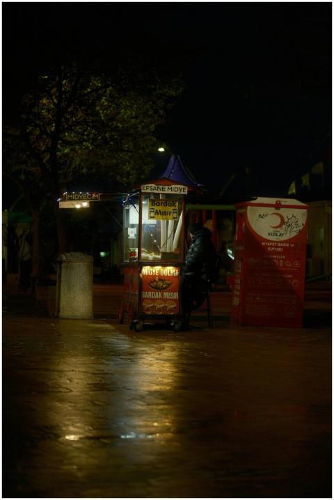 Outdoor street food stall at night in Degirmendere