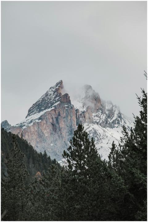 A scenic view of a snow-covered mountain peak surr
