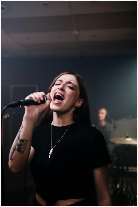 Dynamic singer passionately performing with band d