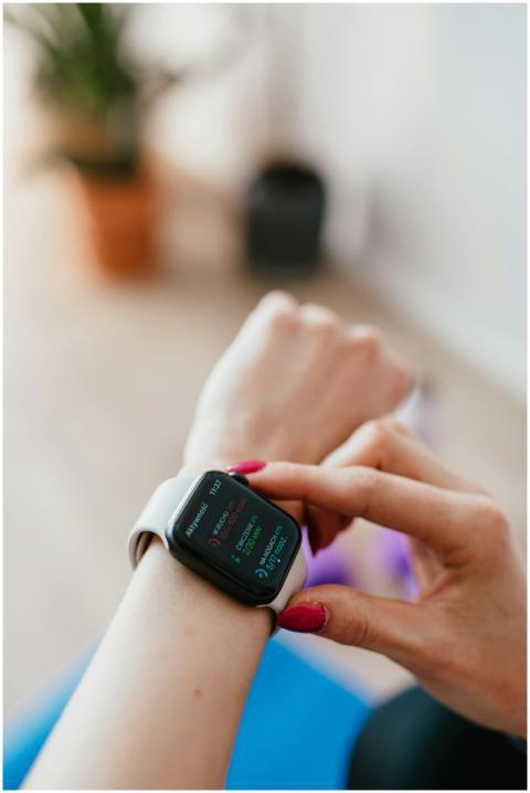 Woman checks her fitness data on a smartwatch, hig