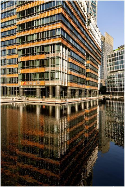 Contemporary office buildings reflected in still w