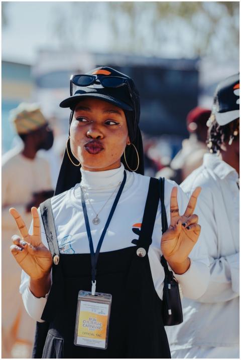 Joyful woman at a vibrant outdoor festival, flashi