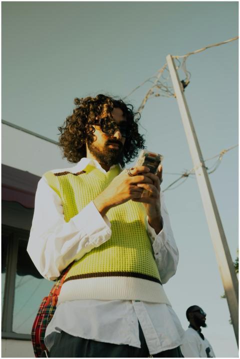 Urban scene of a fashionable man with curly hair c