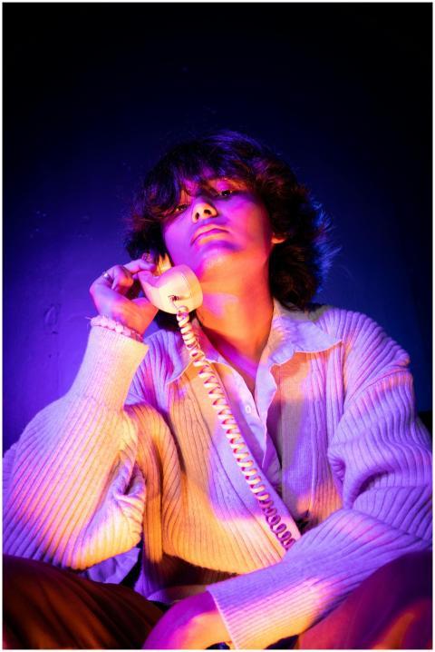 Moody portrait of a person using a vintage phone i