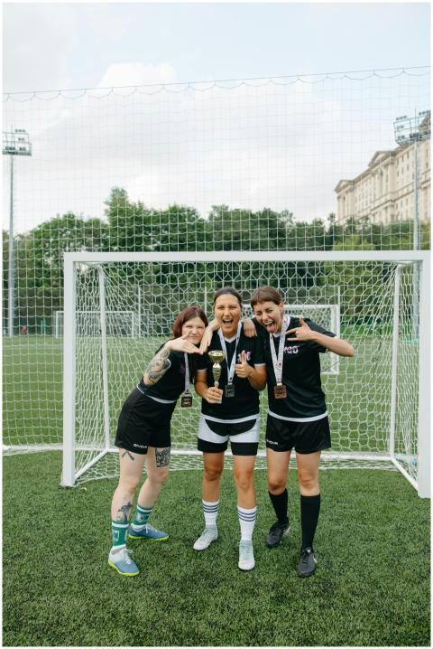 Joyful women footballers celebrating victory with