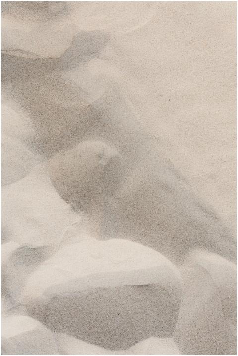 Abstract close-up of textured sand and rocks, high