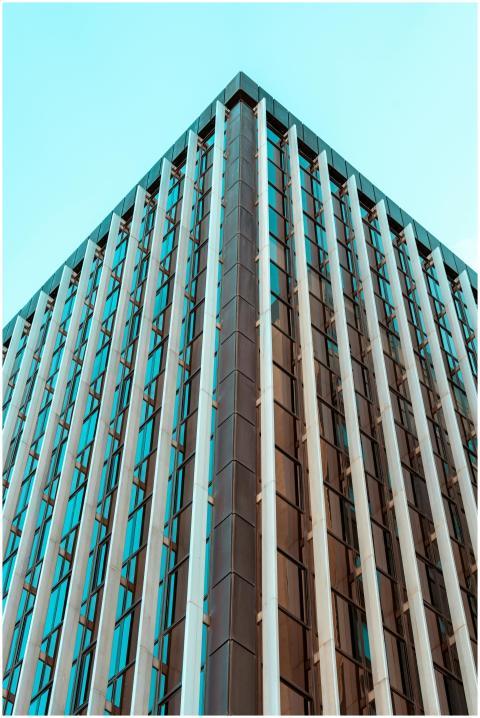 Corner view of a contemporary glass skyscraper in