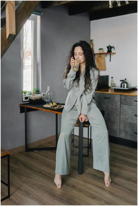 A woman enjoys a calming morning drink in a cozy k