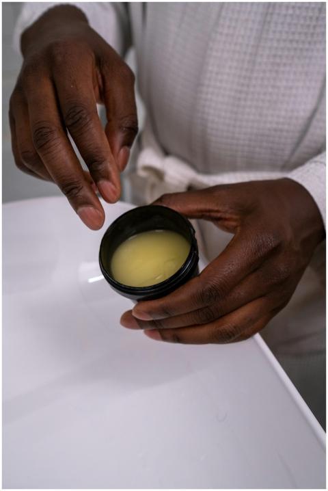 Close-up of hands holding a jar of cream, perfect