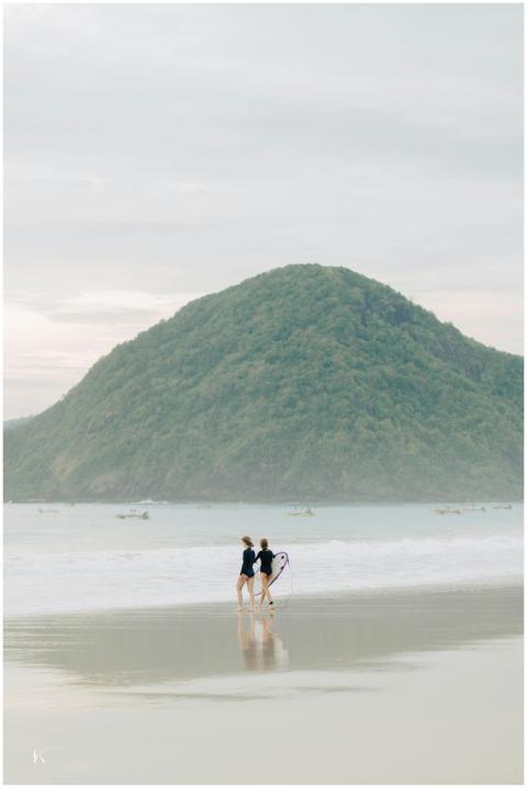 Surfers Strolling Tropical Beach