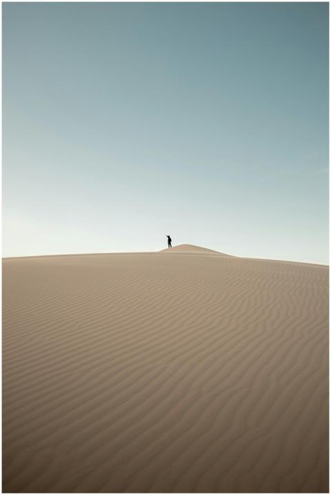 A solitary figure atop the Samalayuca dunes under