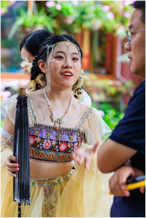 Young woman in vibrant traditional costume interac