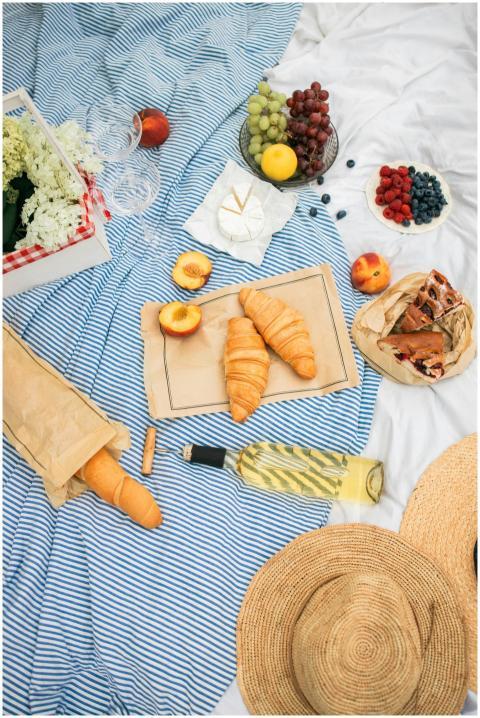 A charming picnic scene with fresh fruits, pastrie