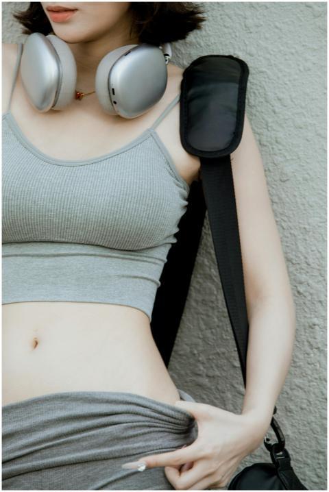 Stylish young woman wearing headphones and a casua