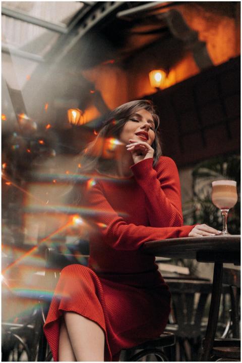 Fashionable woman in a red dress posing gracefully