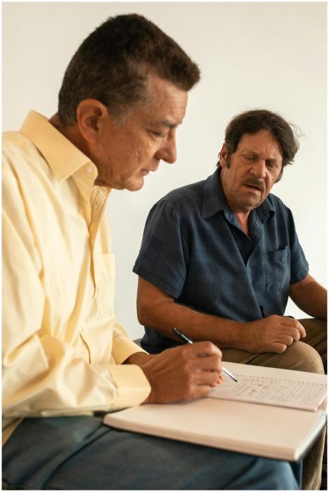 Elderly men studying together in a bright room, fo