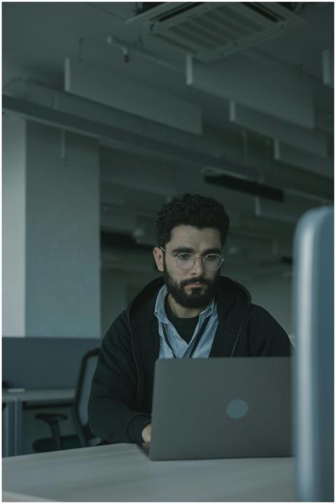 A focused man working on his laptop in a modern of