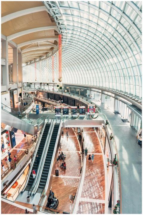 Spacious indoor shopping mall with glass ceilings