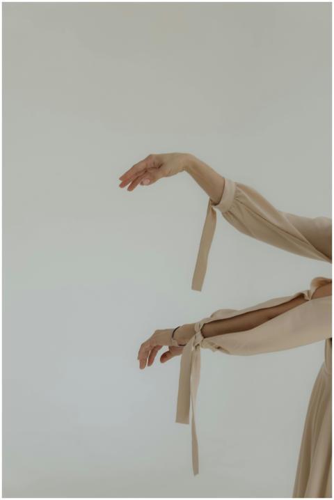 Graceful image of a woman's hands in a beige flowi