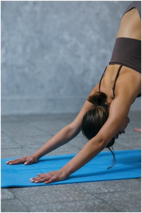 A woman practicing yoga in a peaceful indoor setti