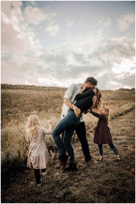 A joyful family shares a loving moment outdoors, s