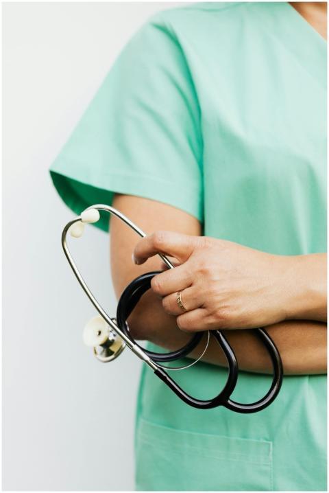 Close-up of a healthcare professional in scrubs ho