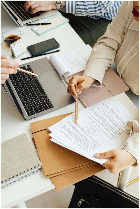 Top view of colleagues working together with a lap