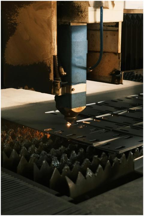 Close-up of a laser cutter in action, showcasing m