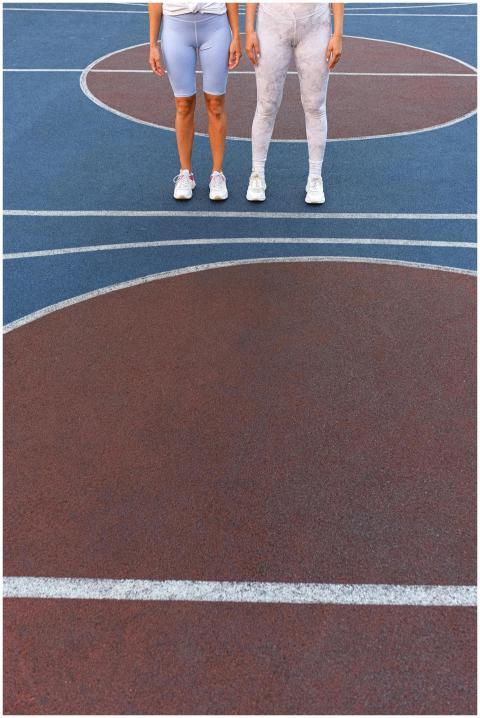 Two women wearing leggings standing on a colorful
