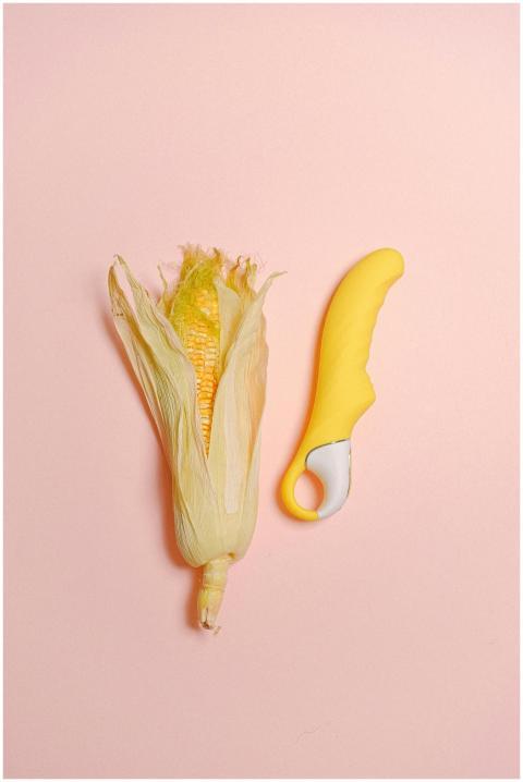 A creative still life featuring a corn cob and yel