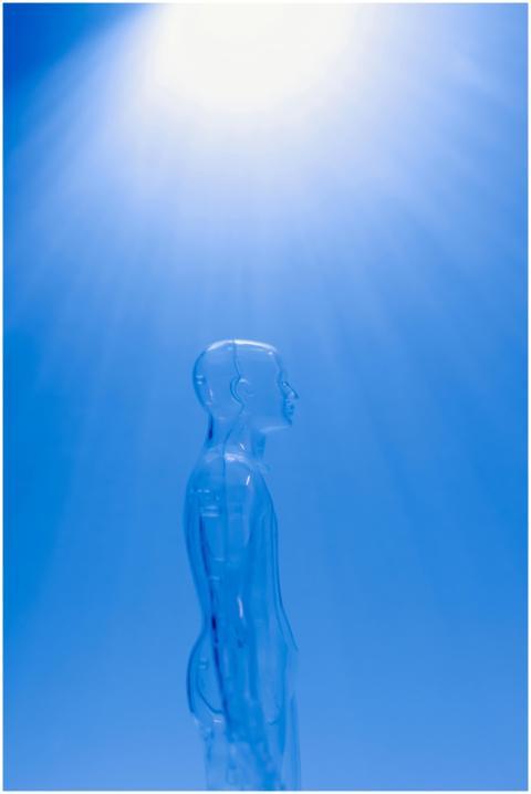 A transparent human figure under a bright blue lig