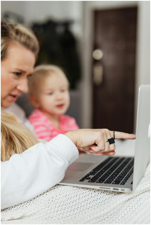 Mother and child sitting on a sofa, interacting wi
