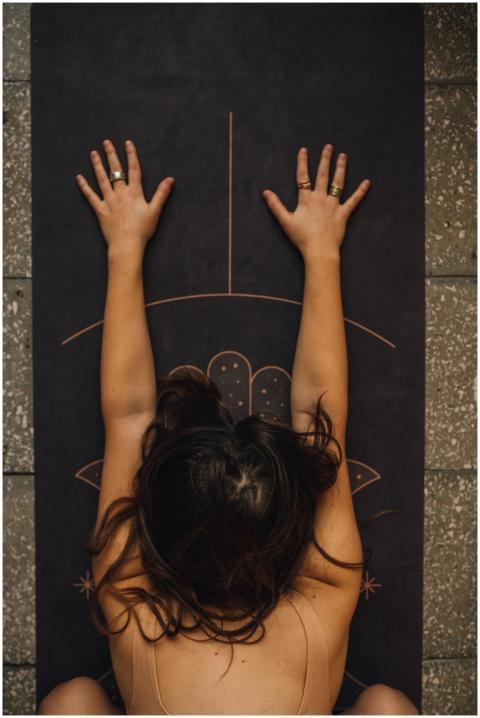 Woman practicing calming yoga pose on a detailed m