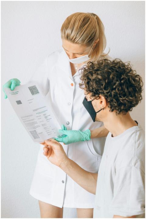 A healthcare worker and patient discussing a COVID