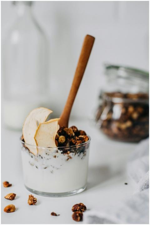 Fresh granola yogurt parfait topped with apple sli