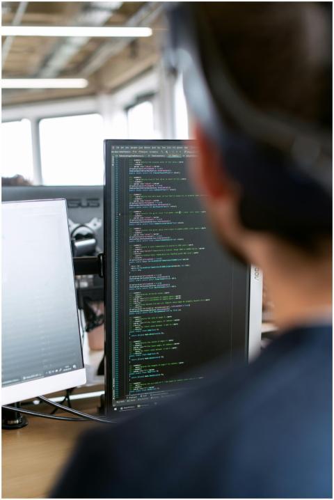 A male software engineer working on code in a mode