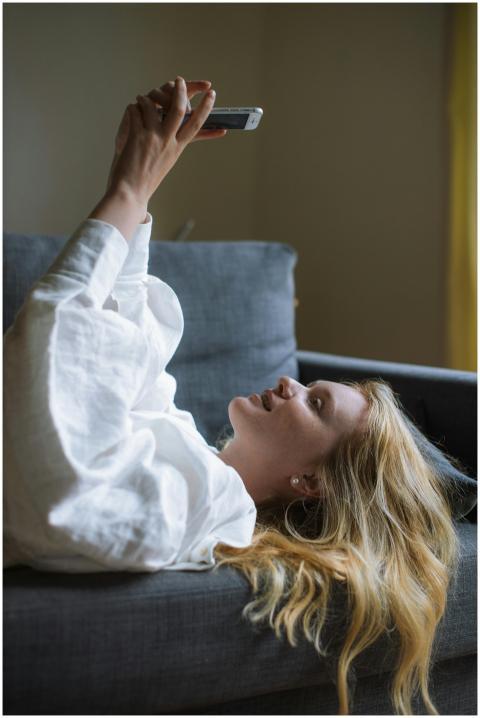 Young woman with blonde hair taking a selfie while